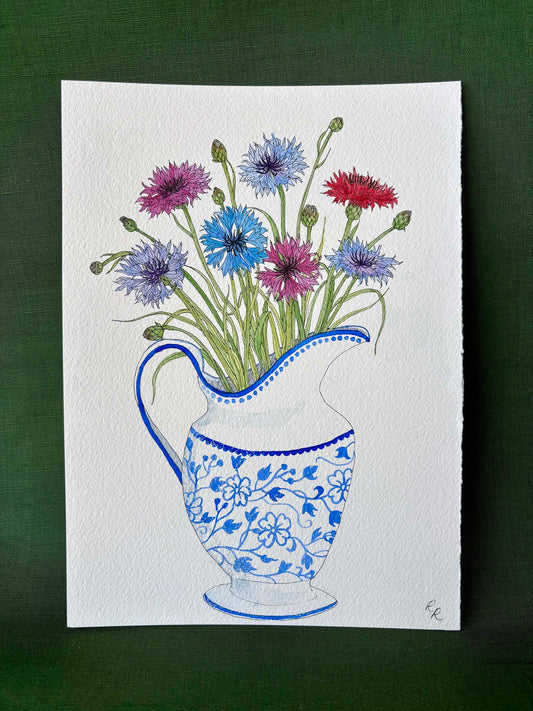 A square watercolor painting of a blue and white patterned pitcher filled with colorful cornflowers