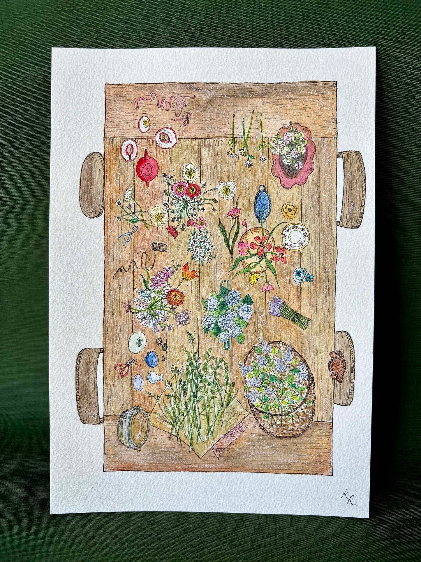 A colorful hand-drawn illustration of a wooden table covered with flowers, herbs, and small decorative objects