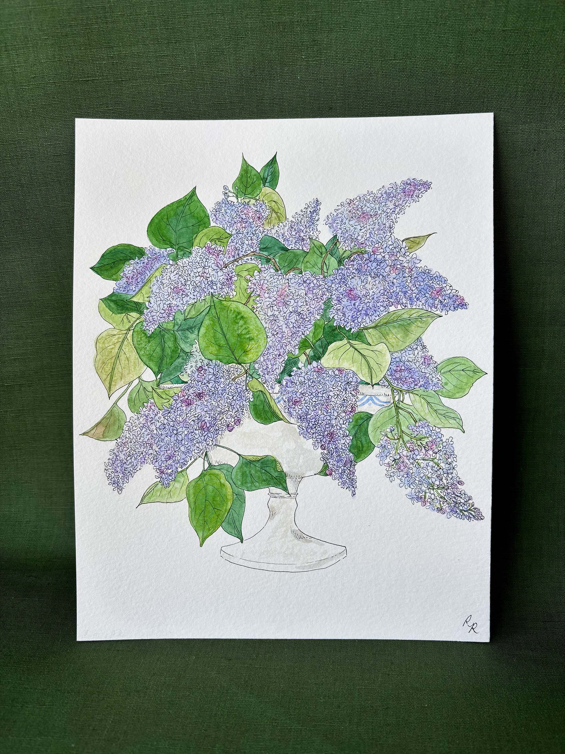 A botanical art print depicting a bouquet of purple lilacs and green leaves in a white vase.