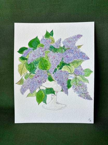 A botanical art print depicting a bouquet of purple lilacs and green leaves in a white vase.