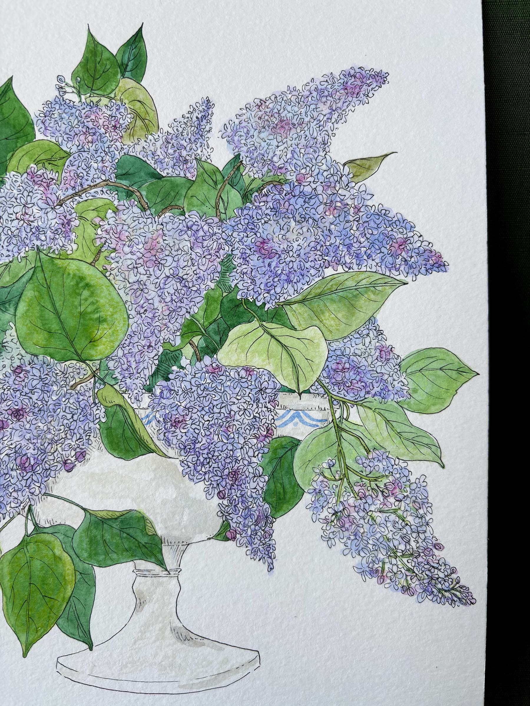 A watercolor and ink illustration of a large bouquet of purple lilacs with green leaves in a white pedestal vase, set against a textured white paper background.