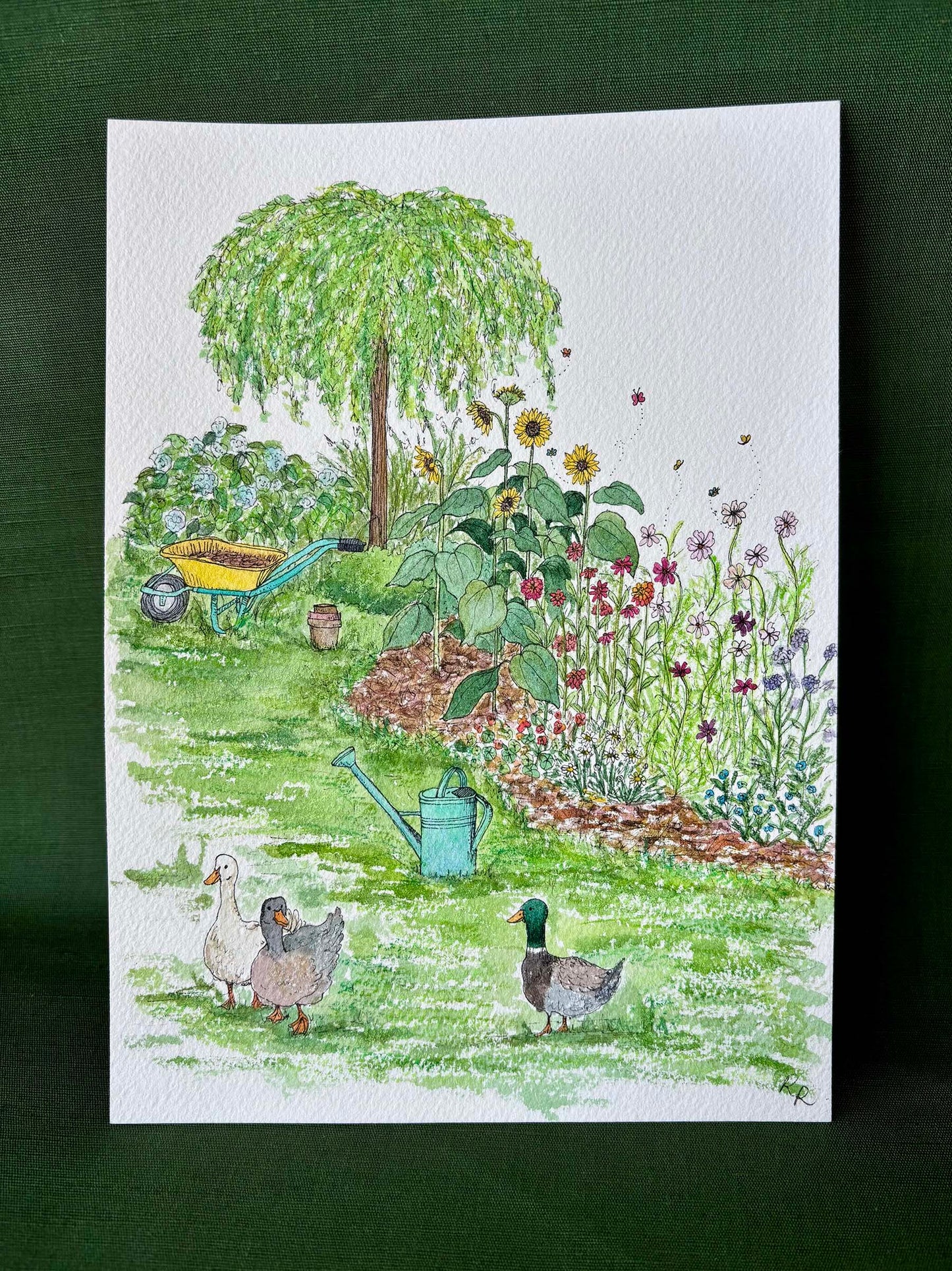 A watercolor garden illustration featuring a weeping tree, sunflowers, a wheelbarrow, a watering can, and three ducks.